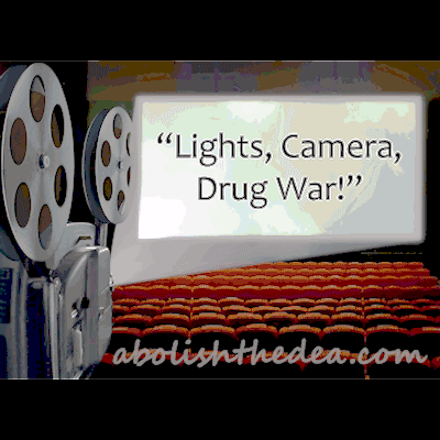 An old-fashioned reel-to-reel projector as seen from the projectionist booth in a an empty theater, projecting the following words on the big screen: 'Lights, camera, Drug War!'