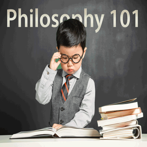  Child dressed as professor, wearing suit and tie and glasses and studying philosophy text in front of chalkboard. (abolishthedea.com)