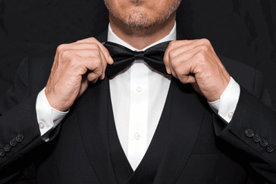 The Essay Proper (from the Drug War Philosopher at abolishthedea.com) man straightening bowtie for his tuxedo